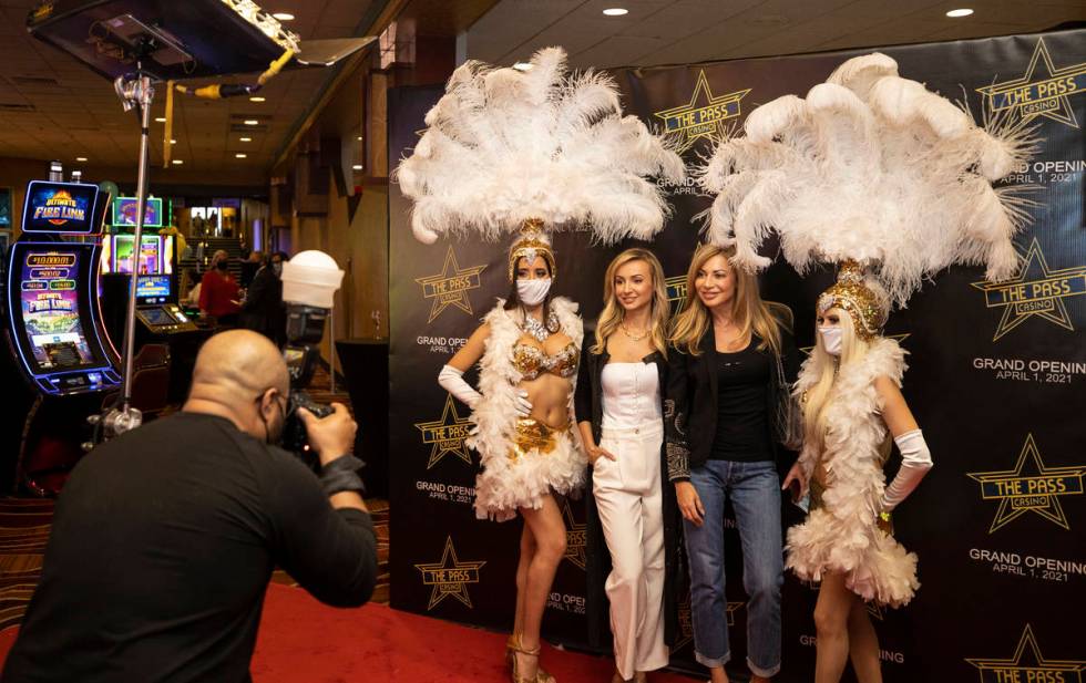 Olesea Stoian, left, and Roxana Tamburro take a photo with showgirls during the VIP opening par ...