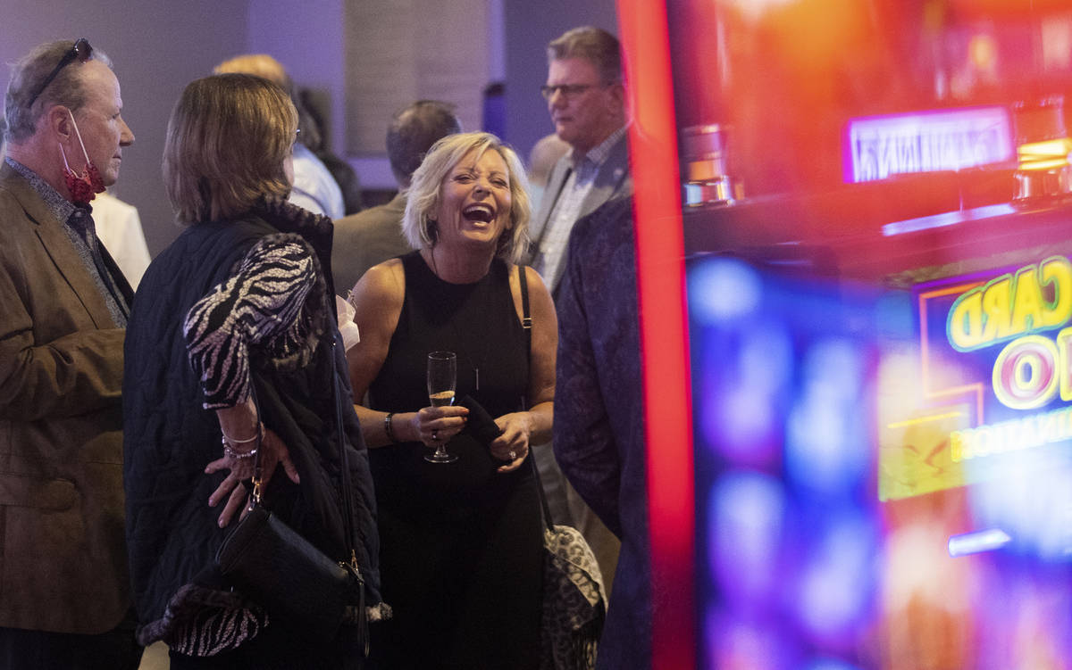 Kerre Slayton, middle, shares a laugh with friends during the VIP opening party for The Pass ca ...