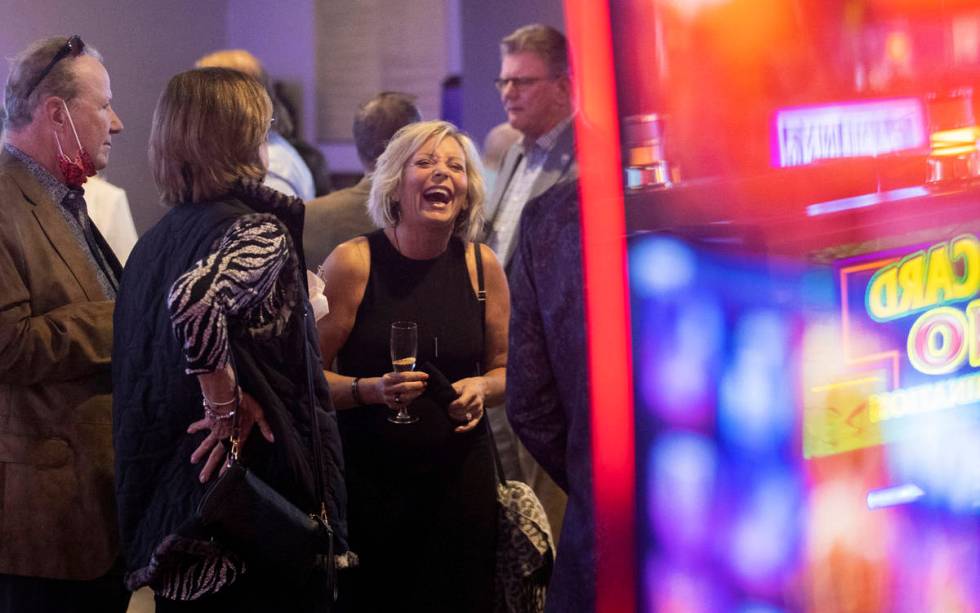 Kerre Slayton, middle, shares a laugh with friends during the VIP opening party for The Pass ca ...
