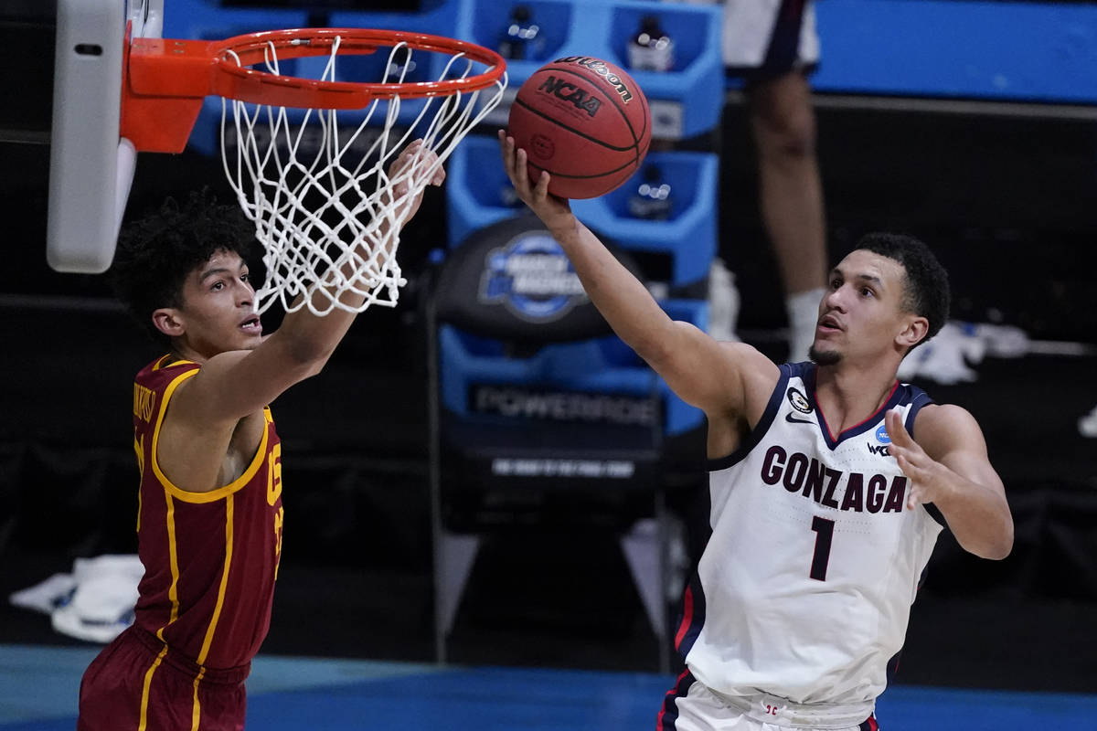 Gonzaga guard Jalen Suggs (1) shoots ahead of Southern California forward Max Agbonkpolo, left, ...