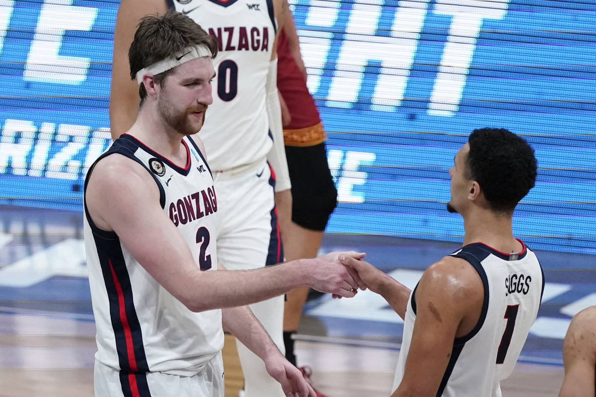 Gonzaga forward Drew Timme (2) celebrates with teammate Jalen Suggs (1) after an Elite 8 game a ...