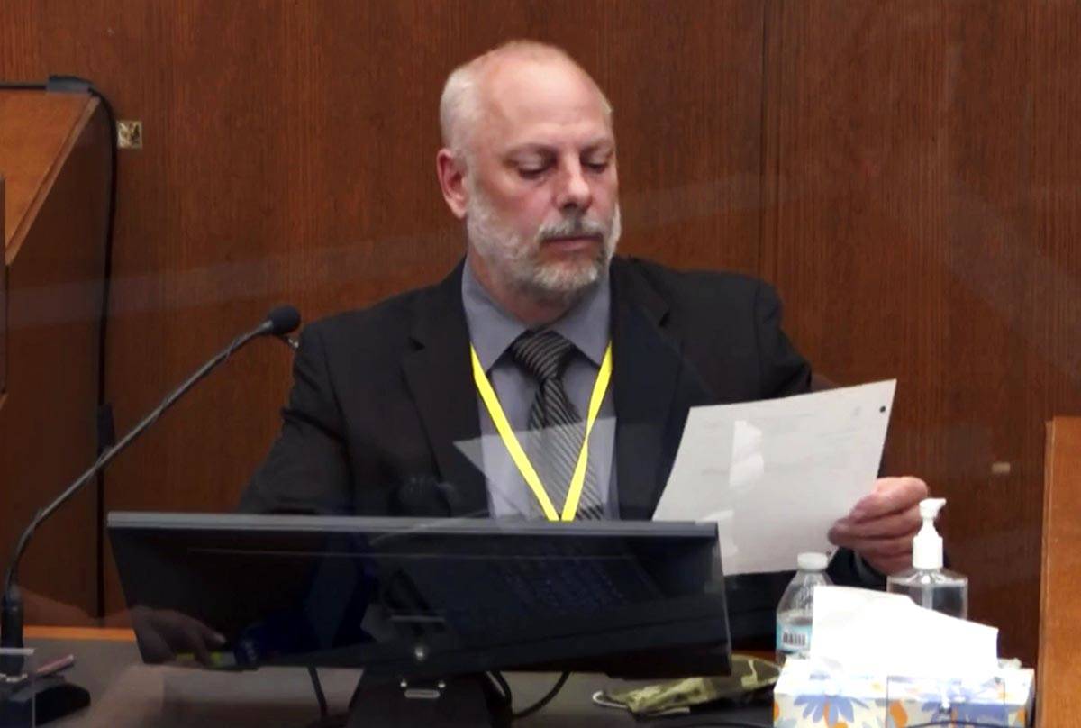 In this image from video, witness David Pleoger, a retired Minneapolis police sergeant reviews ...