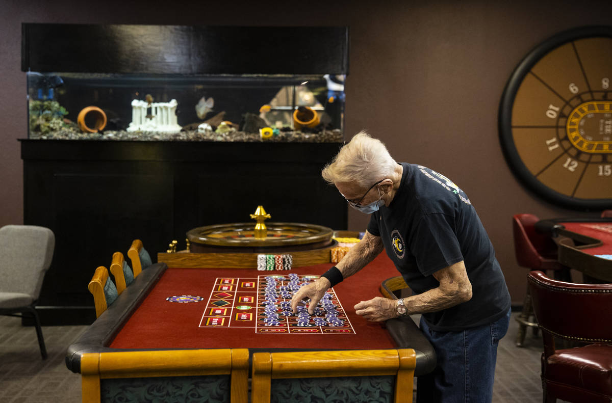 Robert Poletta, 88, arranges chips at a roulette table during class at the Crescent School of G ...