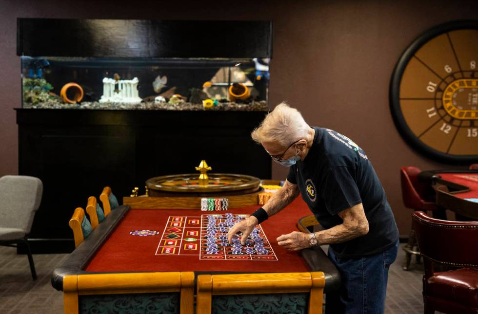 Robert Poletta, 88, arranges chips at a roulette table during class at the Crescent School of G ...
