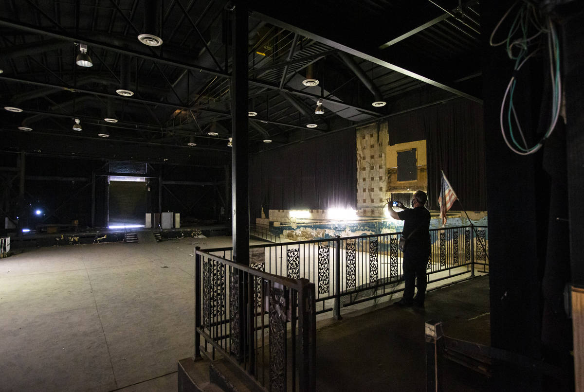A reporter takes a picture in the Huntridge Theater the day after Dapper Companies founder and ...