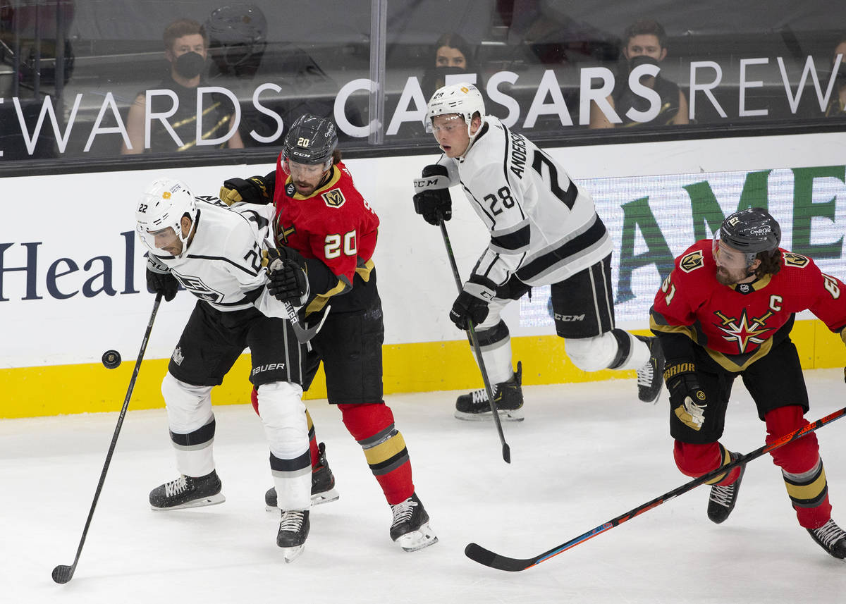 Kings left wing Andreas Athanasiou (22) and Golden Knights center Chandler Stephenson (20) eye ...
