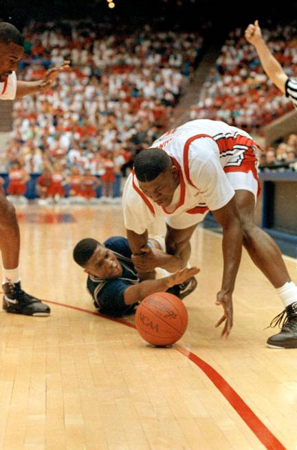UNLV's Larry Johnson manages to get the ball away from Georgetown's Robert Churchwell during ac ...