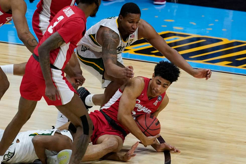 Baylor guard Mark Vital, top, fights for a loose ball with Houston guard Quentin Grimes, right, ...