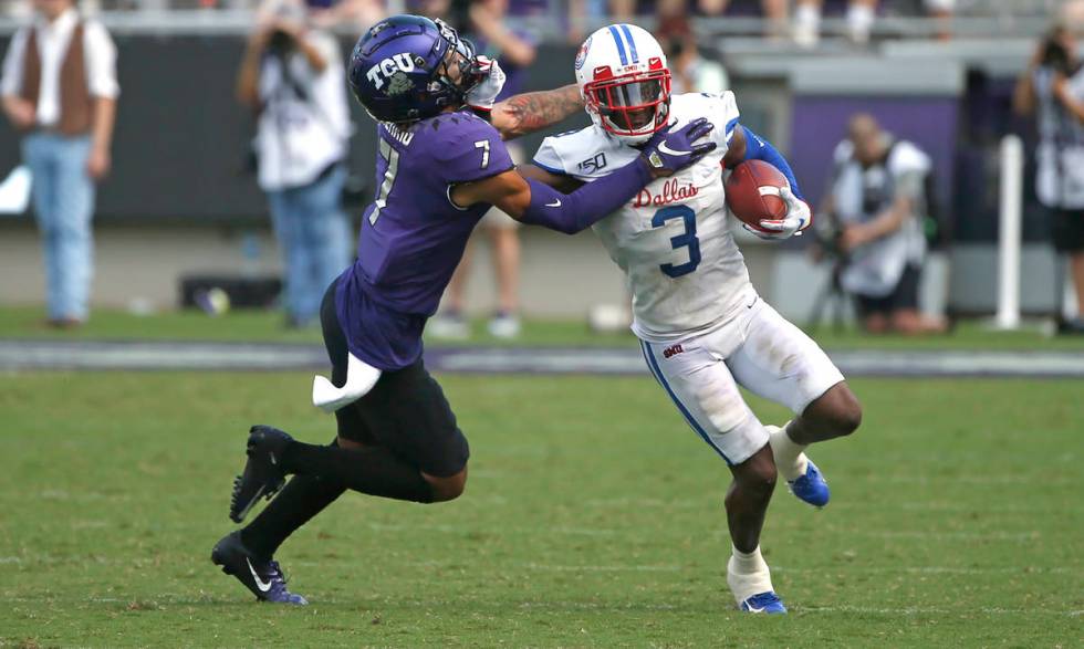 TCU safety Trevon Moehrig (7) pushes SMU wide receiver James Proche (3) toward the sideline aft ...