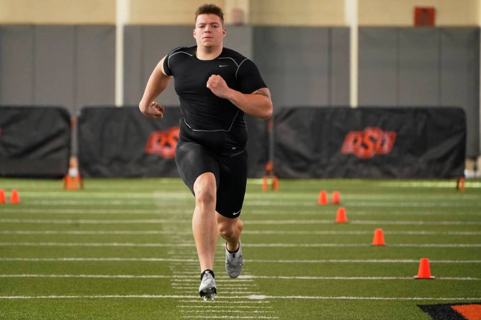 Oklahoma state offensive lineman Teven Jenkins runs the 40-yard dash at NFL football pro day, T ...