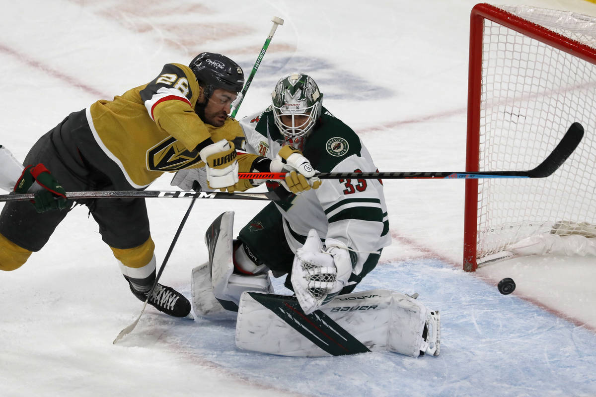 Vegas Golden Knights left wing William Carrier (28) tries to shoot agains Minnesota Wild goalte ...