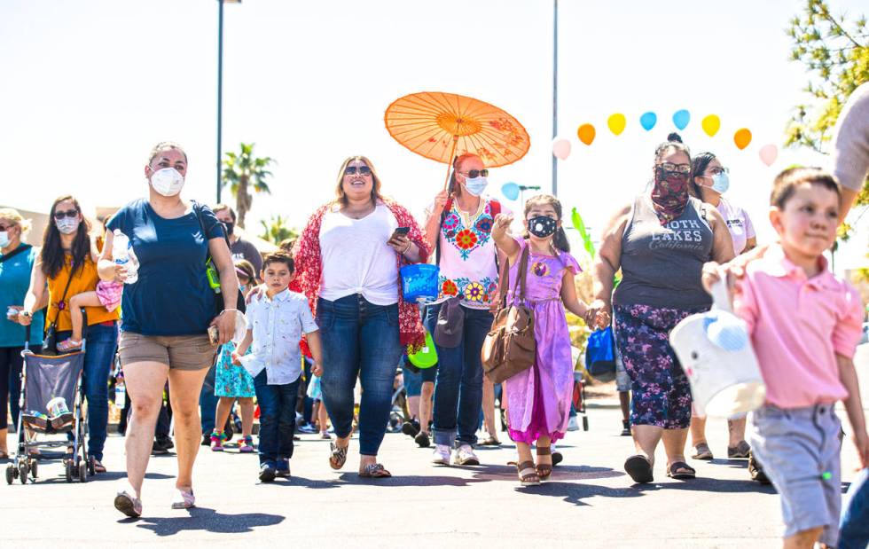 A crowd of people enter an Easter egg hunt and carnival sponsored by The JET Foundation, which ...