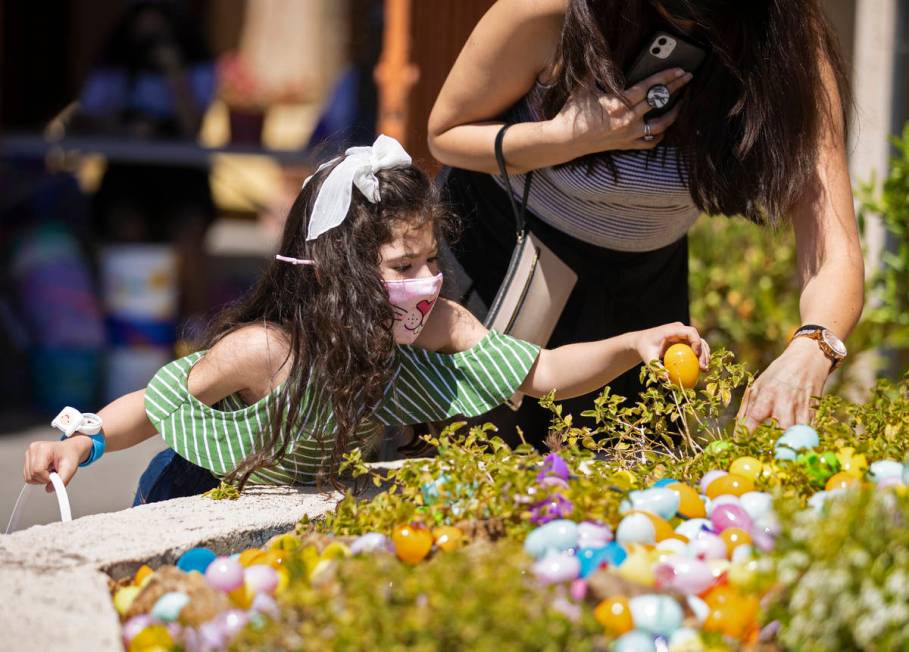 Jaclyne Herrera, left, 4, and Vivian Leby hunt for Easter eggs during an Easter egg hunt and ca ...