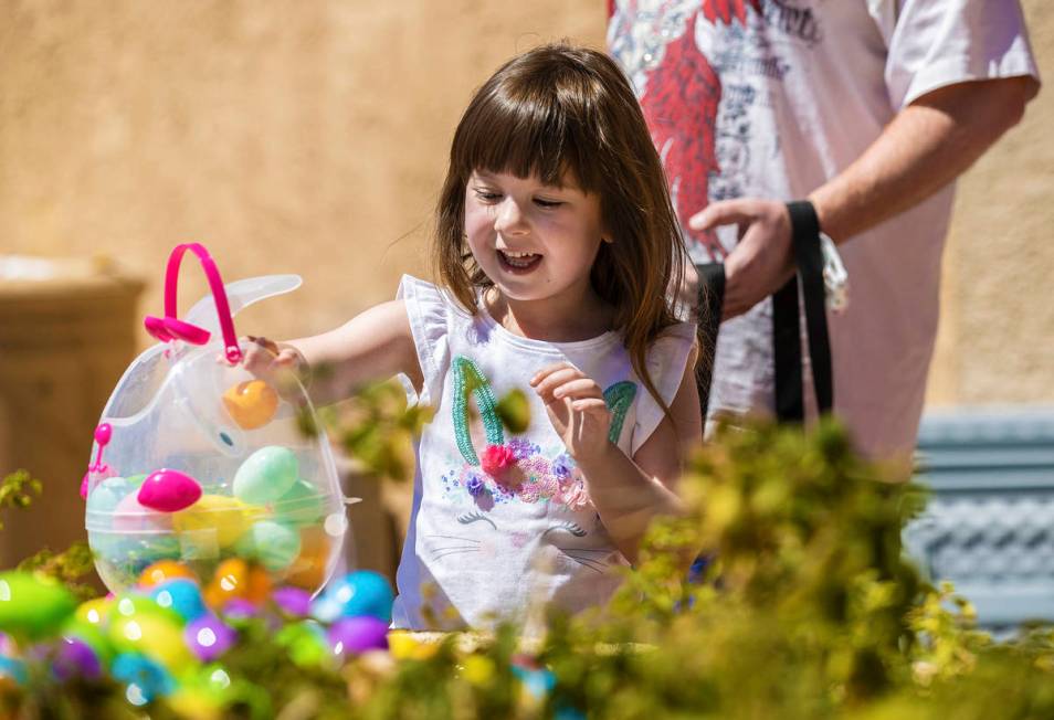Athena Freeman, 5, collects Easter eggs during an Easter egg hunt and carnival sponsored by The ...