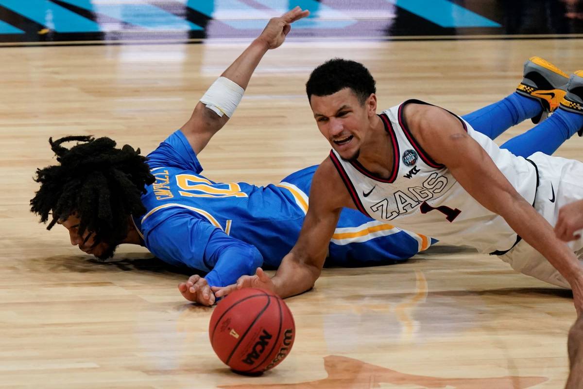 Gonzaga guard Jalen Suggs (1) scrambles for a loose ball with UCLA guard Tyger Campbell (10) du ...