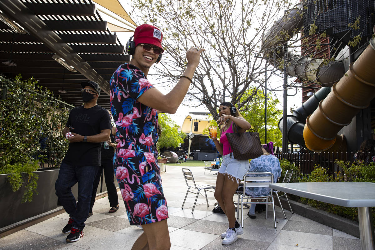 Deonndrae Phillips, second from left, dances with sister Aya Phillips, right, during a silent d ...
