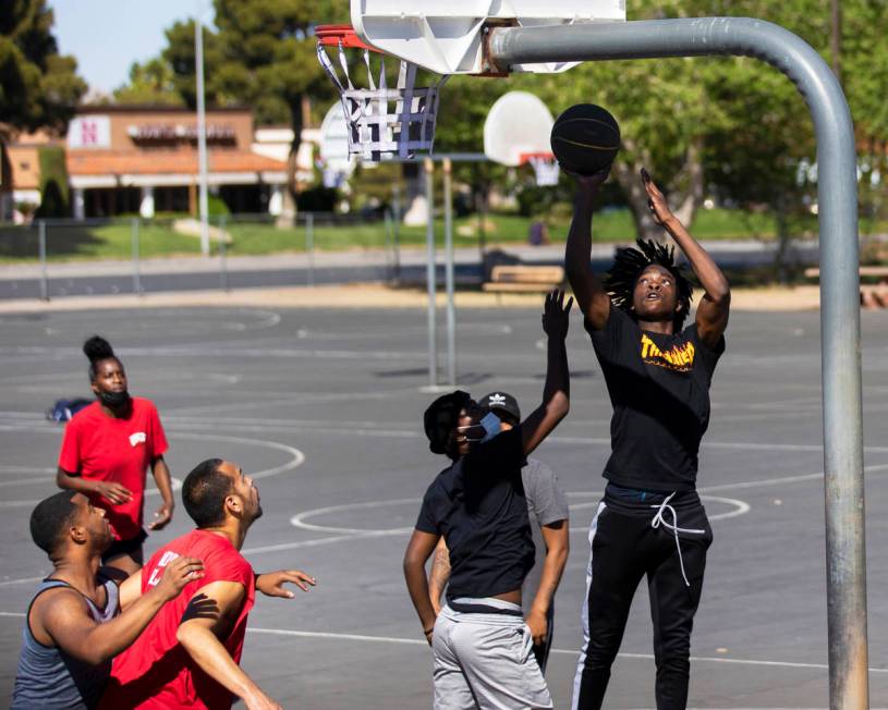 Players play a game of pickup basketball at Sunset Park on Saturday, April 3, 2021, in Las Vega ...