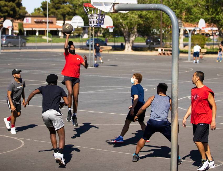 Players play a game of pickup basketball at Sunset Park on Saturday, April 3, 2021, in Las Vega ...