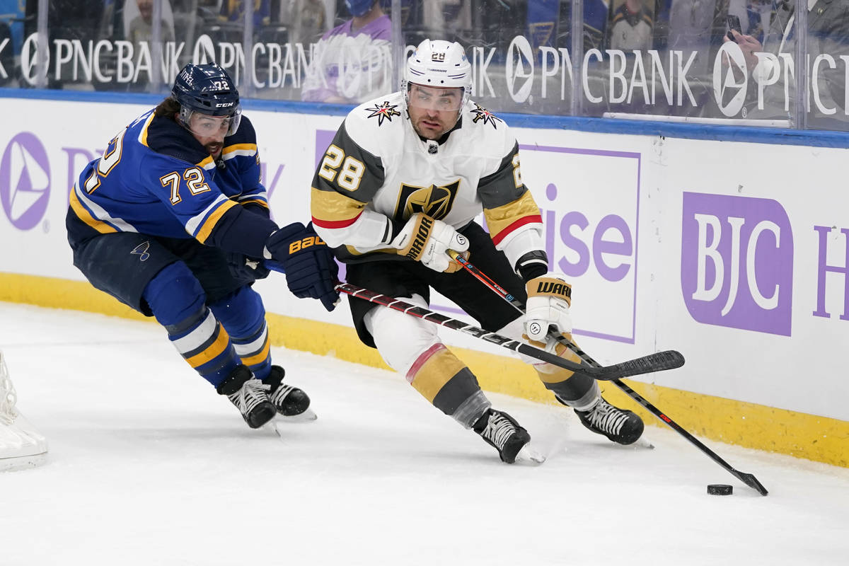 Vegas Golden Knights' William Carrier (28) controls the puck as St. Louis Blues' Justin Faulk ( ...