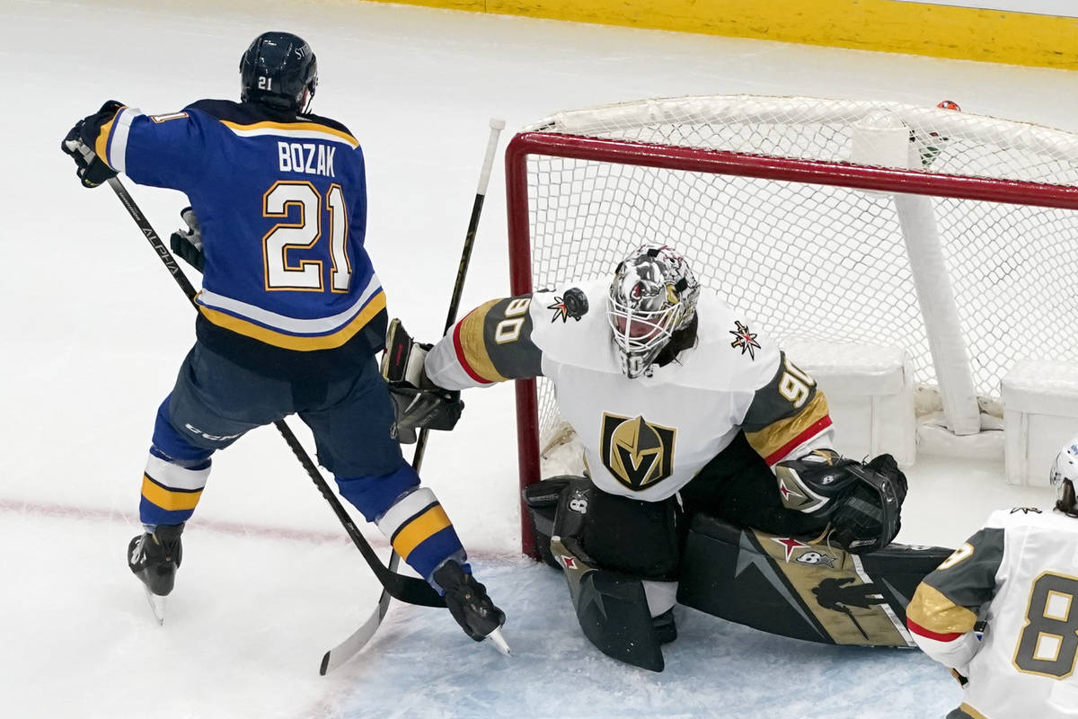 A puck hangs in the air in front of Vegas Golden Knights goaltender Robin Lehner (90) as St. Lo ...