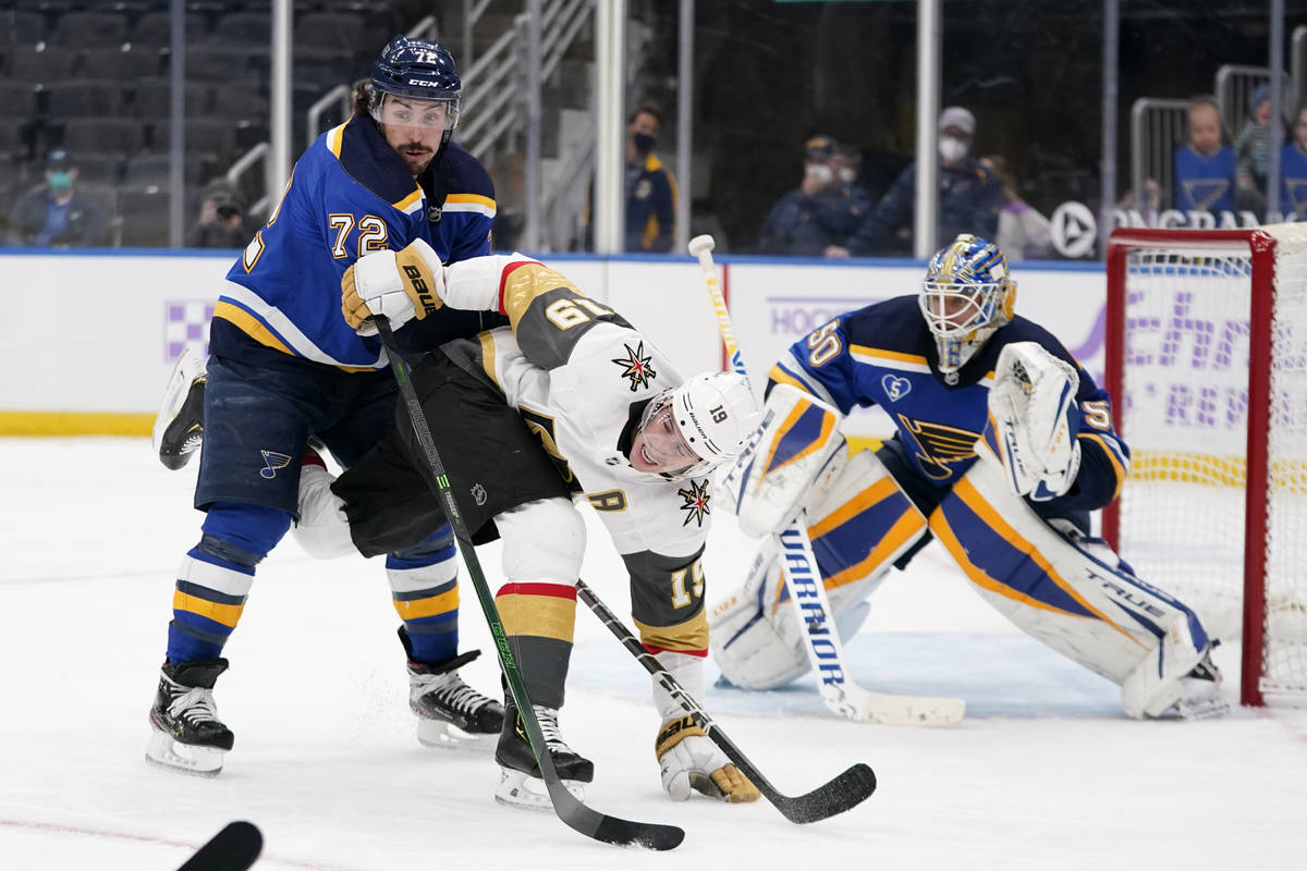 Vegas Golden Knights' Reilly Smith gets tangled up with St. Louis Blues' Justin Faulk (72) as B ...