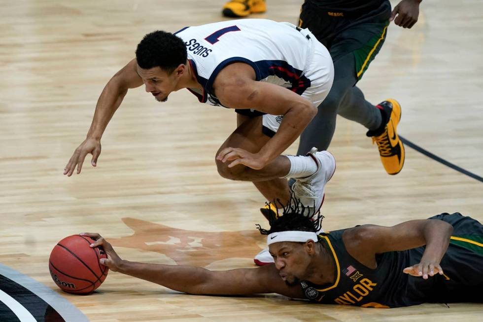 Baylor forward Flo Thamba fights for a loose ball with Gonzaga guard Jalen Suggs (1) during the ...