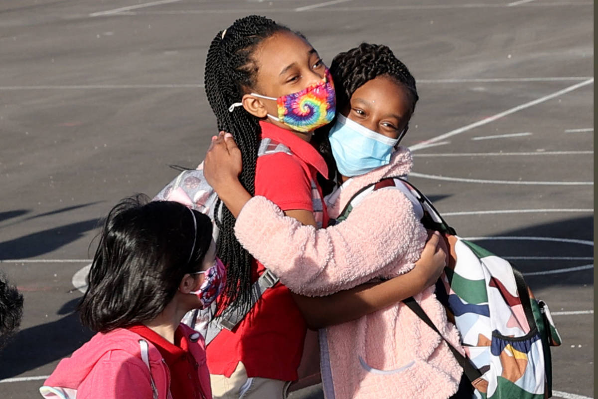 Fourth graders Malinda Bruce, left, and Kailyn Hines, both 10, greet each other for their first ...