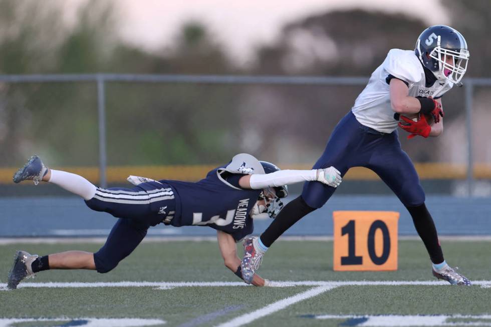 Meadows' Gage Rinetti (3) forces White Pine's Tyler Lawrence (5) out of bounds during a punt re ...