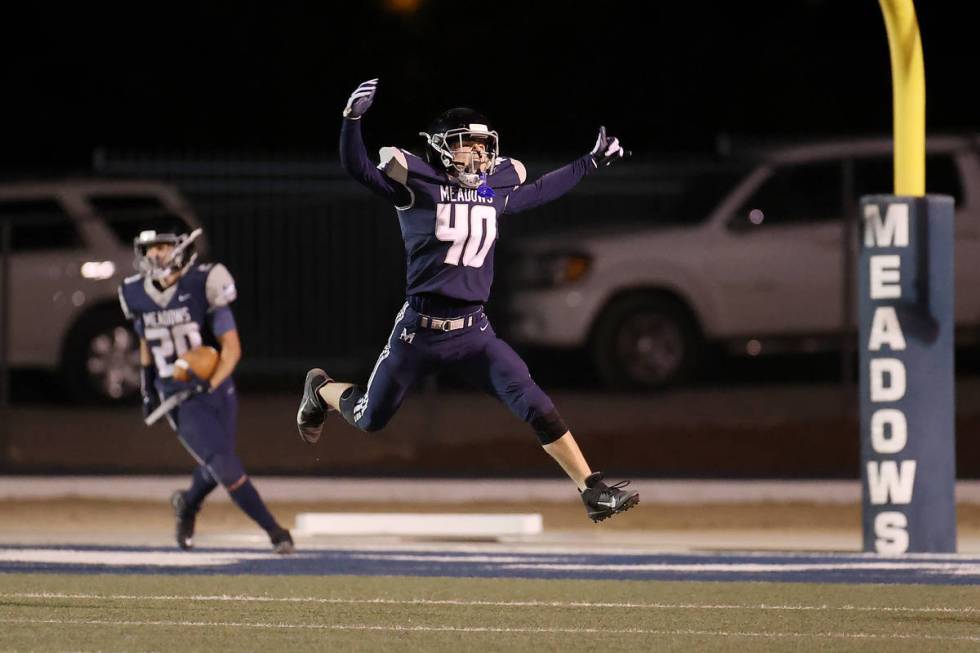 Meadow's Zach Badain (40) celebrates a fumble recovery and run for a touchdown by his teammate ...