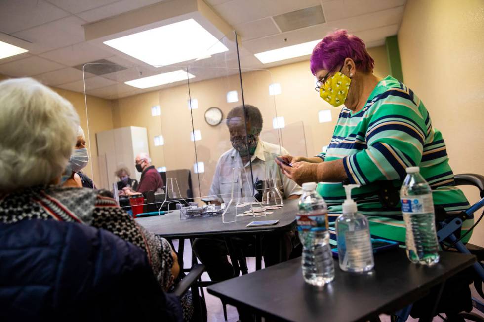 Dotty Ducret, right, and Gordon Dew, center, play the card game canasta at the West Flamingo Se ...