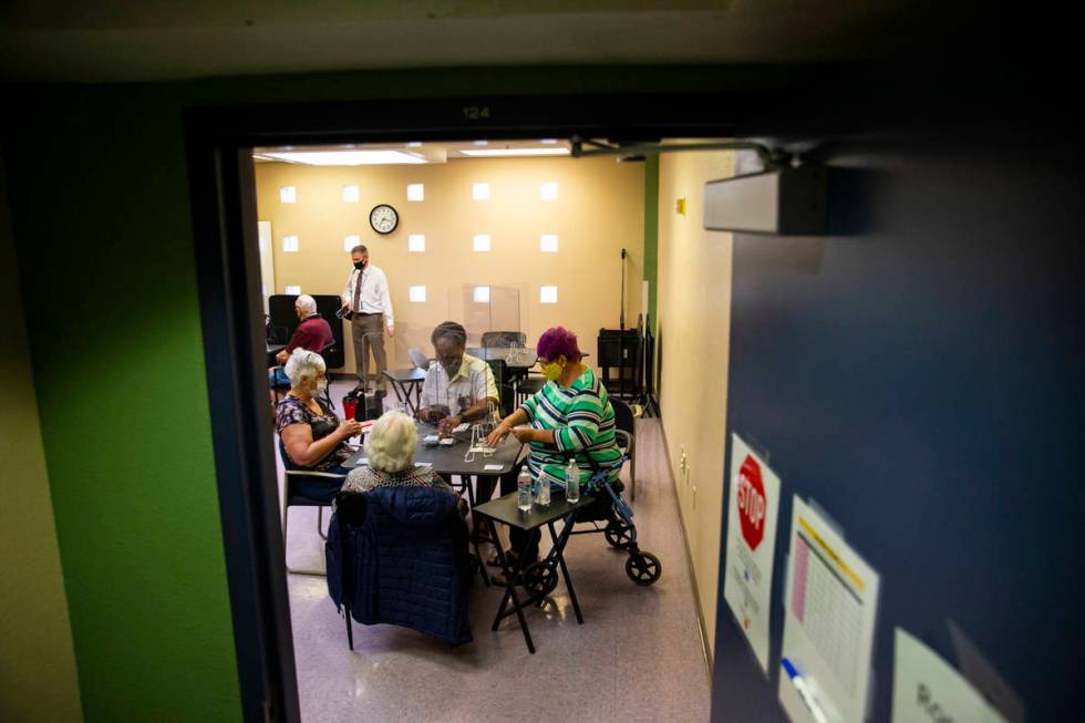 Seniors play the card game canasta at the West Flamingo Senior Center during the first day that ...