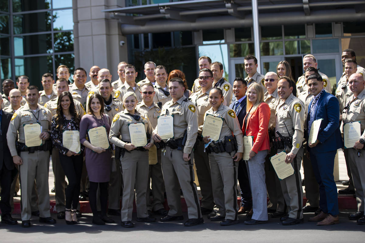 Metropolitan Police Department officers and employees pose for a group picture with their award ...