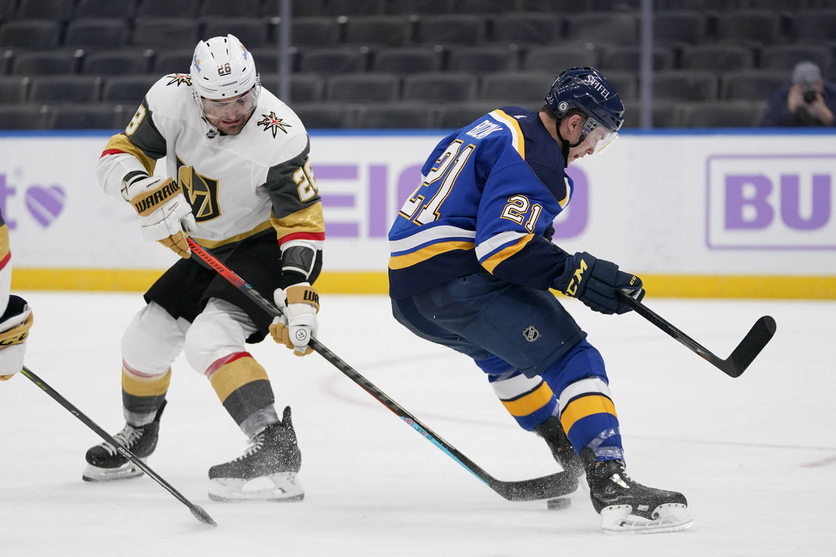 Vegas Golden Knights' William Carrier (28) reaches for the puck as St. Louis Blues' Tyler Bozak ...