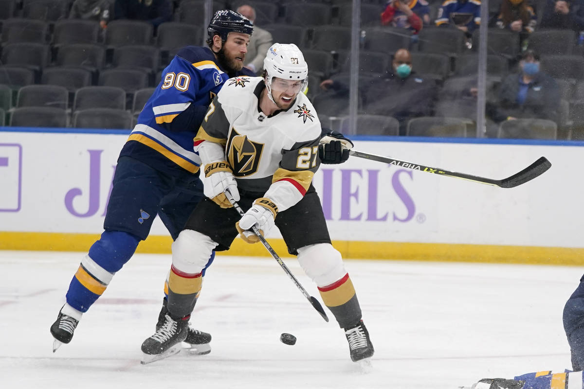 Vegas Golden Knights' Shea Theodore (27) reaches for a loose puck as St. Louis Blues' Ryan O'Re ...