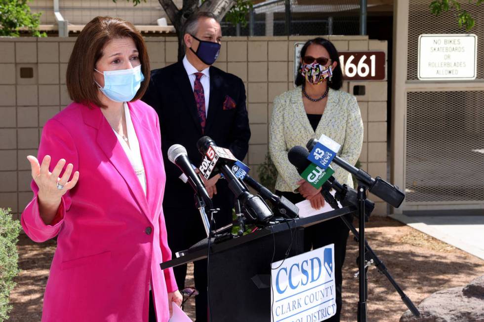 Sen. Catherine Cortez Masto, D-Nev., left, talks to the news media at Hancock Elementary in Las ...