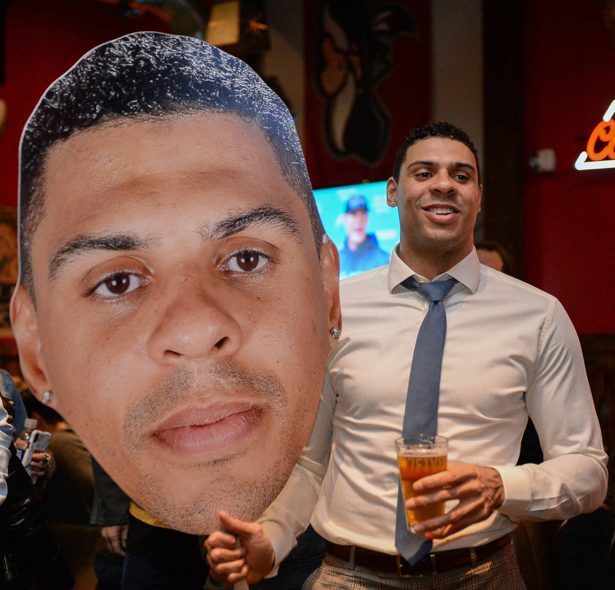 Vegas Golden Knights player Ryan Reaves holds up a cutout of himself at a party for the release ...