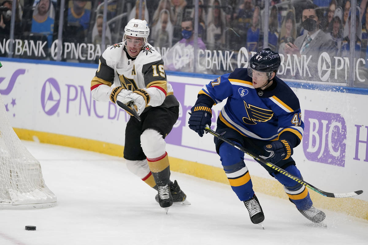 Vegas Golden Knights' Reilly Smith (19) and St. Louis Blues' Torey Krug chase after a loose puc ...