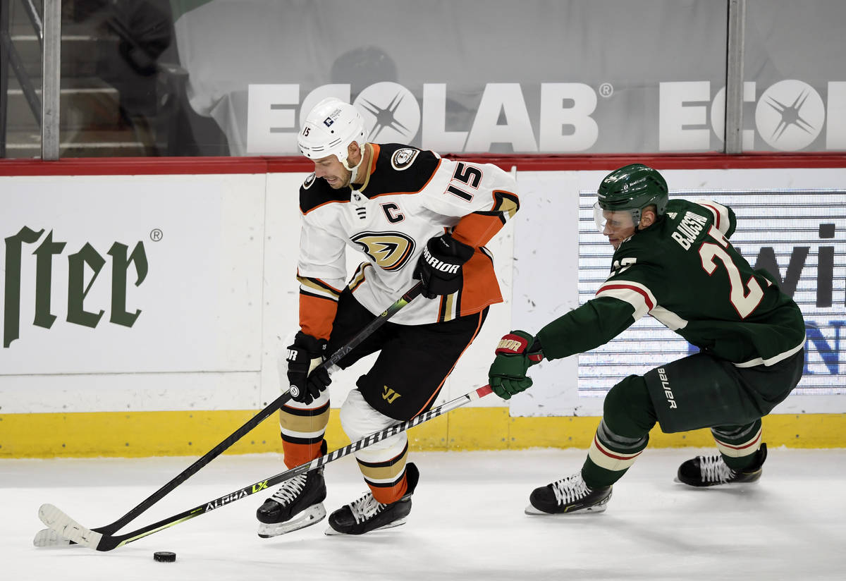 Anaheim Ducks' Ryan Getzlaf (15) is defended by Minnesota Wild's Nick Bjugstad (27) during the ...