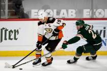 Anaheim Ducks' Ryan Getzlaf (15) is defended by Minnesota Wild's Nick Bjugstad (27) during the ...