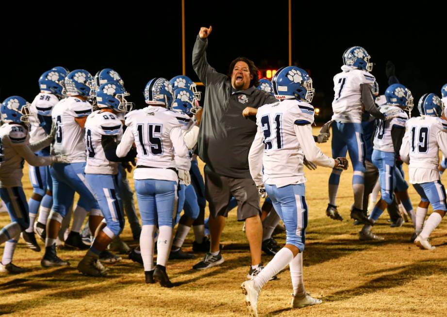 Centennial head coach Dustin Forshee celebrates after his team's 20-7 win over Desert Pines in ...