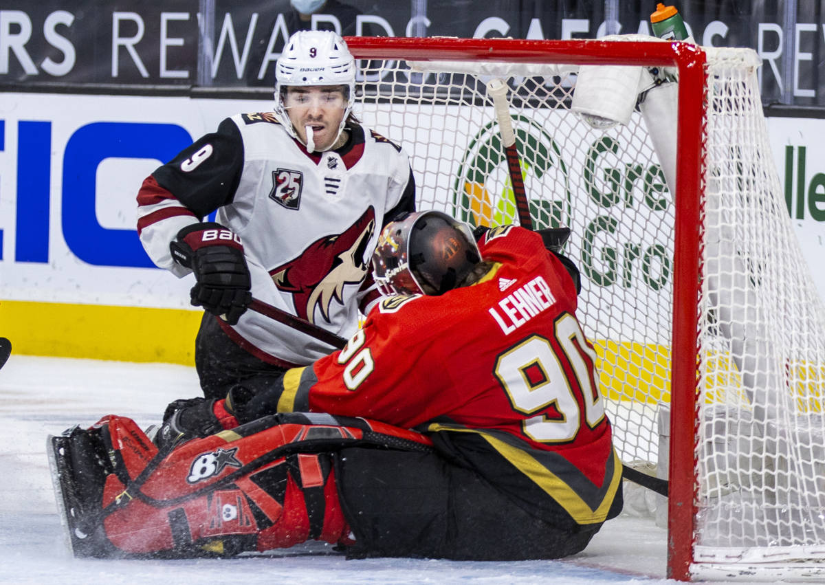 Arizona Coyotes right wing Clayton Keller (9) looks to a stopped puck and Golden Knights goalte ...