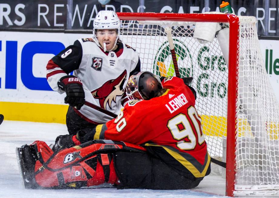 Arizona Coyotes right wing Clayton Keller (9) looks to a stopped puck and Golden Knights goalte ...