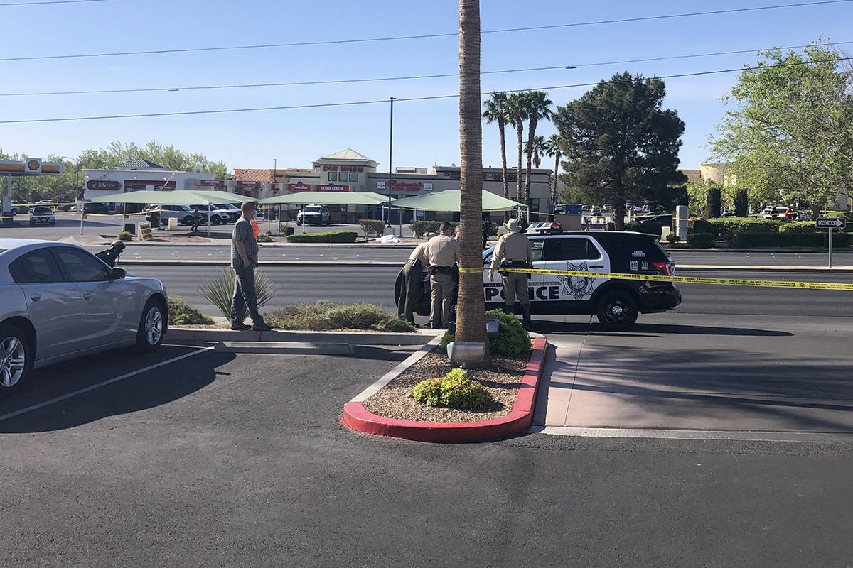 Police investigate a report of a body found Saturday, April 10, 2021, at West Charleston Boulev ...
