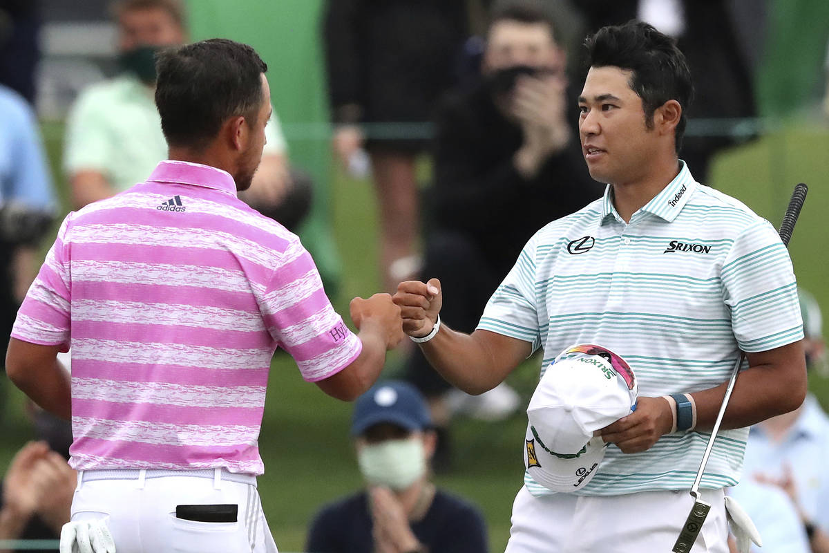 Hideki Matsuyama, right, and Xander Schauffele give each other a fist-bump on the 18th green as ...