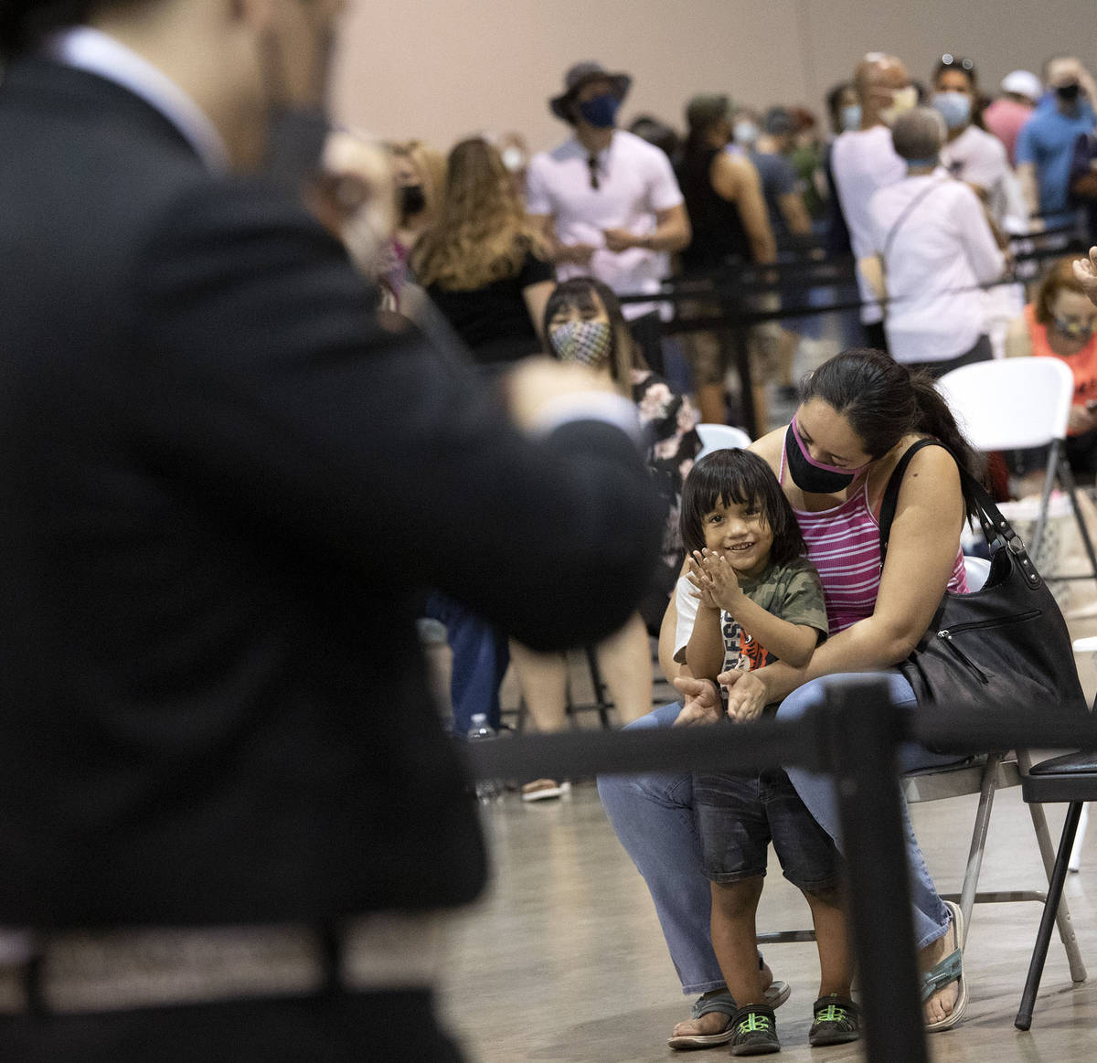 Elizabeth Montanez holds her son, Juan Mejia, 2, as he claps for Mariachi Nuestras Raices' perf ...