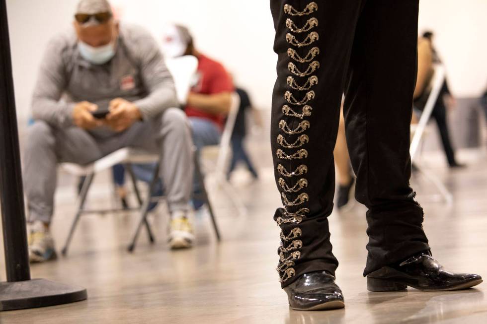 Mariachi Nuestras Raices performs while people wait for 15 minutes after getting the COVID-19 v ...