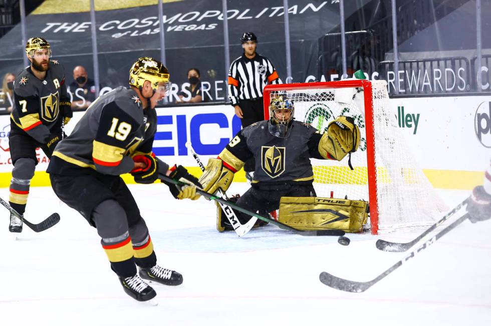 Golden Knights goaltender Marc-Andre Fleury (29) and forward Reilly Smith (19) defend the net a ...