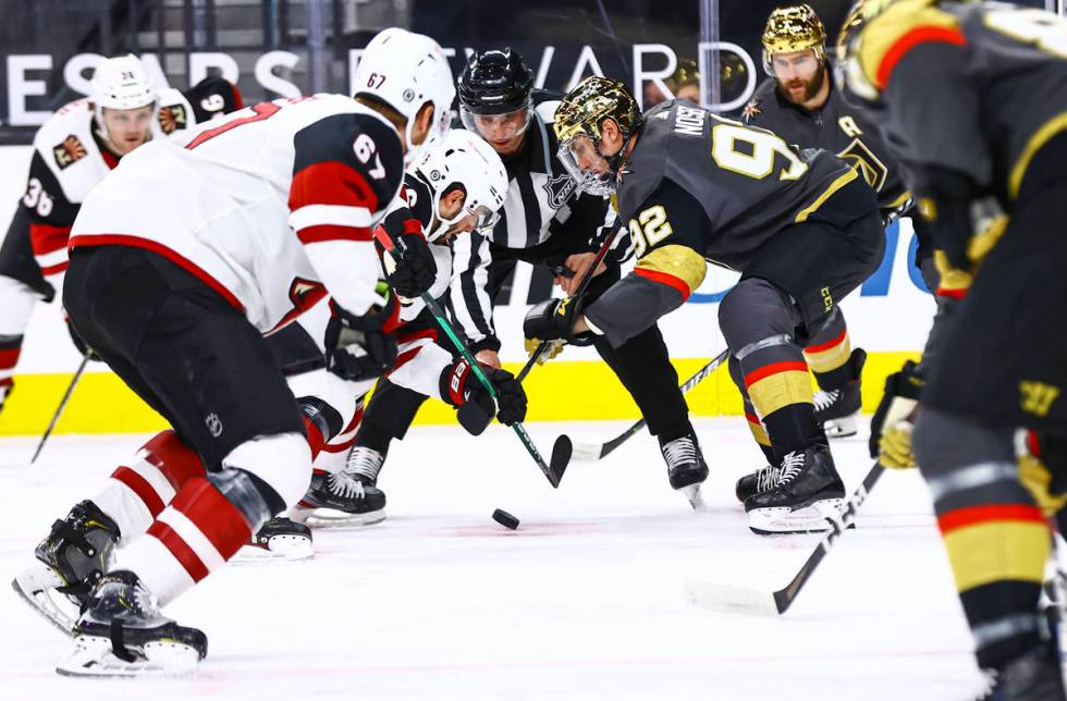 Golden Knights' Tomas Nosek (92) and Arizona Coyotes' Derick Brassard (16) fight for the puck d ...