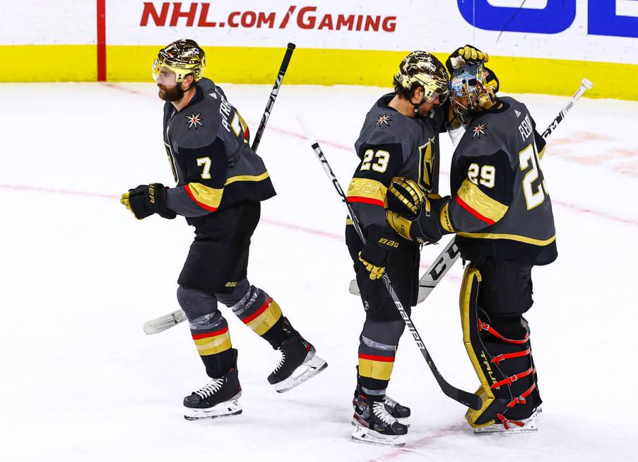 Golden Knights' Alec Martinez (23) celebrates with goaltender Marc-Andre Fleury (29) after a sh ...