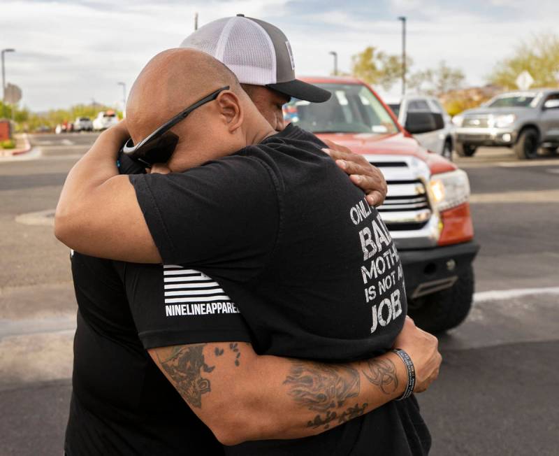 Richard Velasquez, left, father of Aaliyah Velasquez, gets a hug from a Sin City Tundras member ...